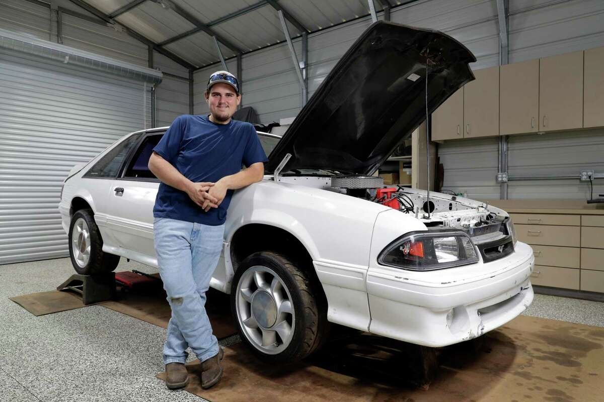 Colton Lowe, who formerly weighed 400 pounds, with his 90s era Mustang at his home garage in Conroe. Lowe bought the car, but could not fit inside, which prompted him to undergo bariatric surgery.