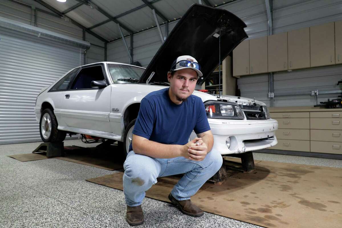 Colton Lowe, who formerly weighed 400 pounds, with his 90s era Mustang at his home garage in Conroe. Lowe bought the car, but could not fit inside, which prompted him to undergo bariatric surgery.