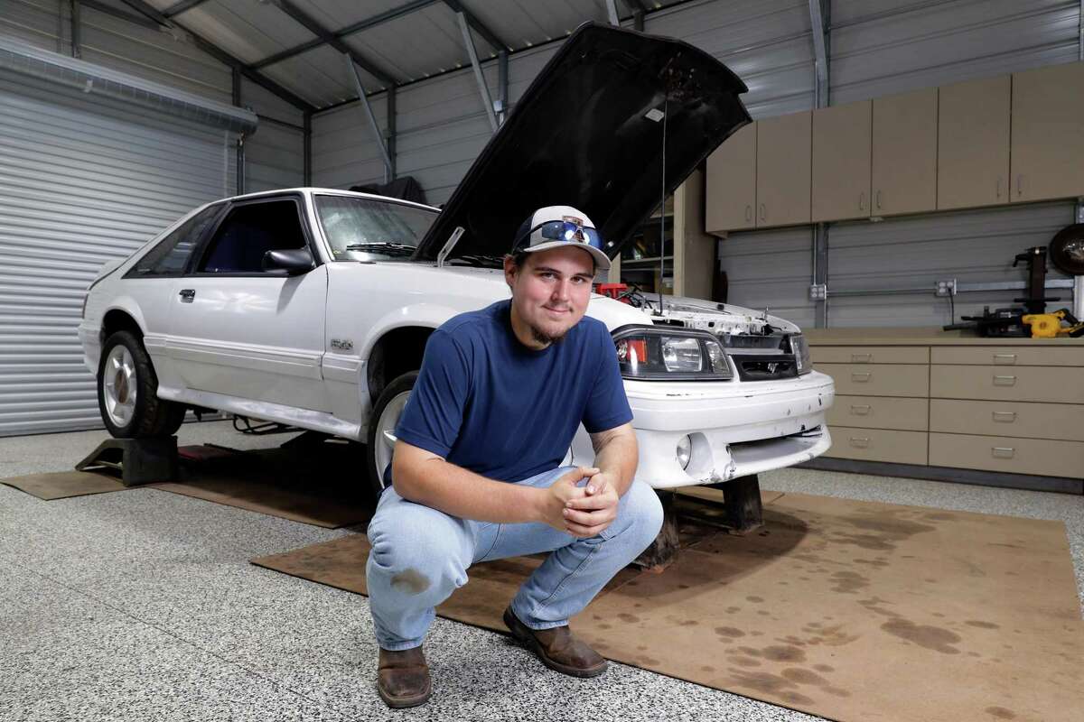 Colton Lowe, who formerly weighed 400 pounds, with his 90s era Mustang at his home garage in Conroe. Lowe bought the car, but could not fit inside, which prompted him to undergo bariatric surgery.