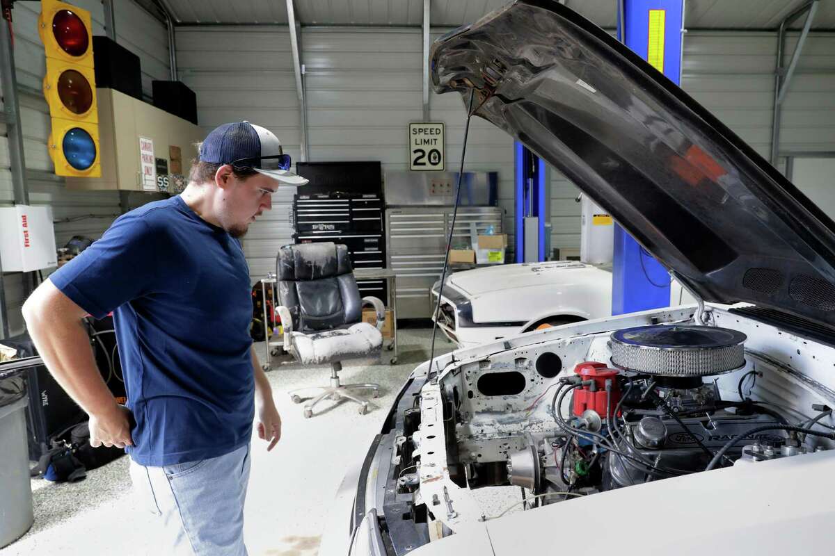 Colton Lowe, who formerly weighed 400 pounds, looks over his 90s era Mustang at his home garage in Conroe. Lowe bought the car, but could not fit inside, which prompted him to undergo bariatric surgery.