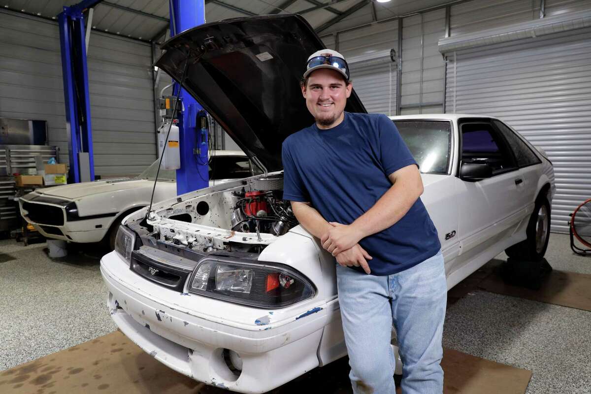 Colton Lowe, who formerly weighed 400 pounds, with his 90s era Mustang at his home garage in Conroe. Lowe bought the car, but could not fit inside, which prompted him to undergo bariatric surgery.