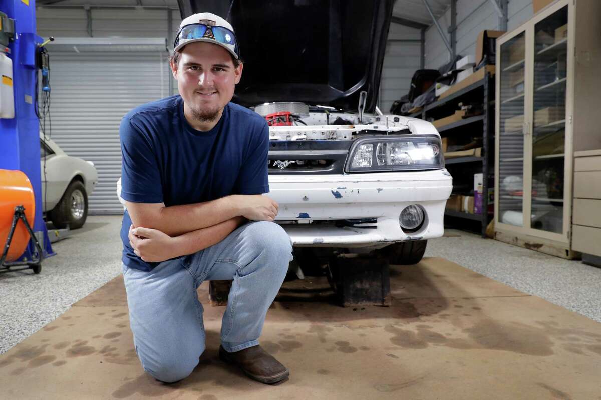 Colton Lowe, who formerly weighed 400 pounds, with his 90s era Mustang at his home garage in Conroe. Lowe bought the car, but could not fit inside, which prompted him to undergo bariatric surgery.