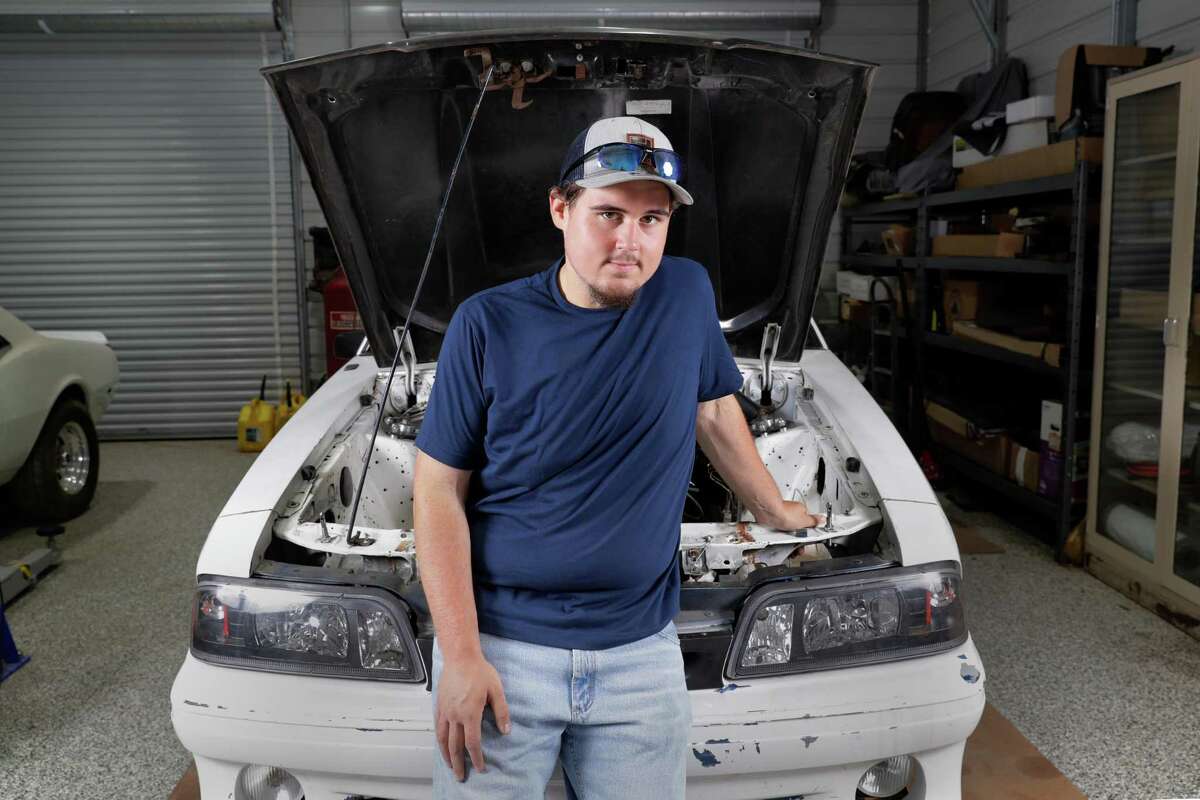 Colton Lowe, who formerly weighed 400 pounds, with his 90s era Mustang at his home garage in Conroe. Lowe bought the car, but could not fit inside, which prompted him to undergo bariatric surgery.