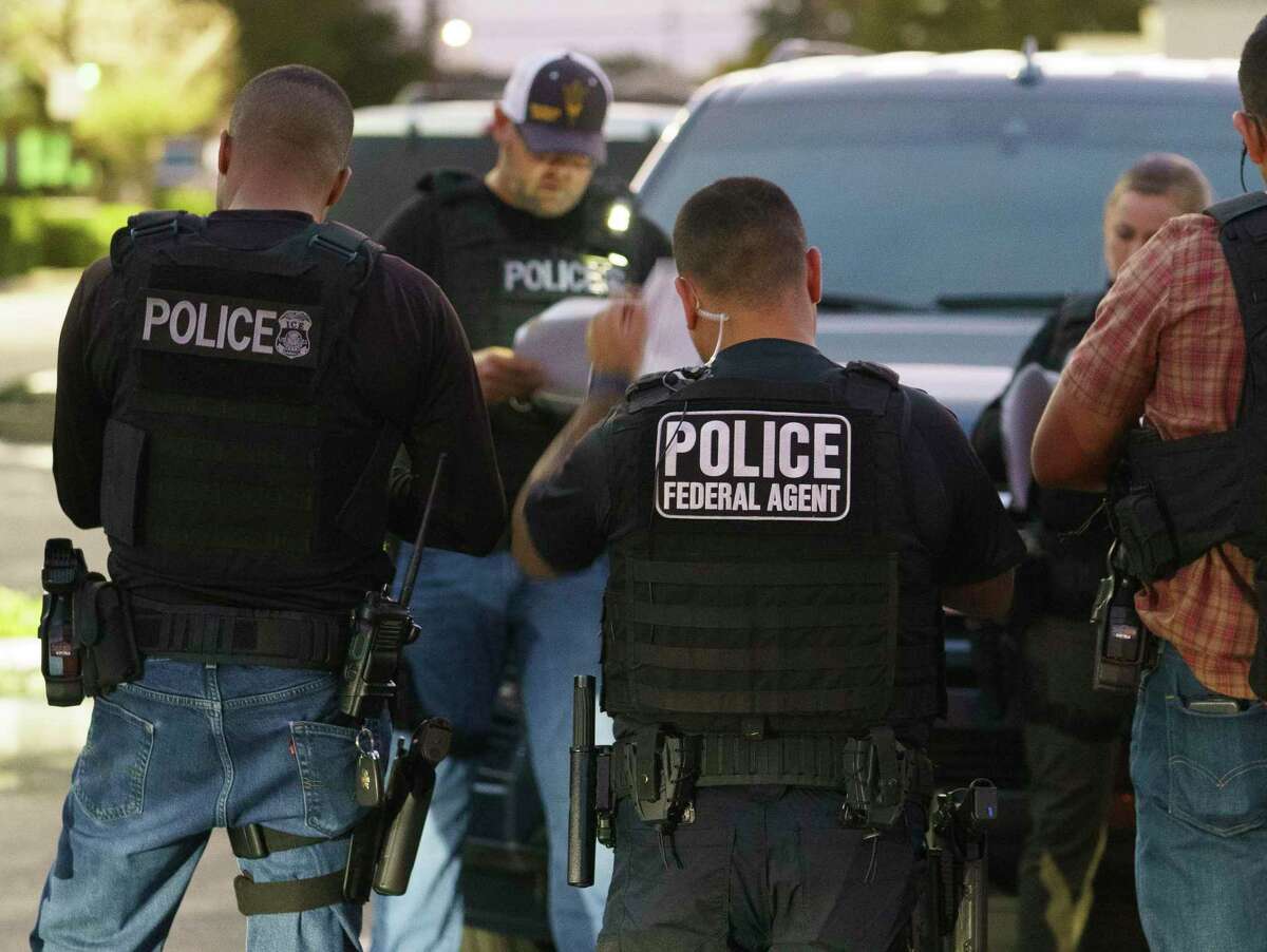 U.S. Immigration and Customs Enforcement agents gather before a June 6 raid in Compton (Los Angeles County).A settlement approved by a federal judge last week prohibits U.S. Immigration and Customs Enforcement offices in San Francisco and Los Angeles from allowing contractors to arrest migrants who are being released from state or local custody and deliver them to ICE.