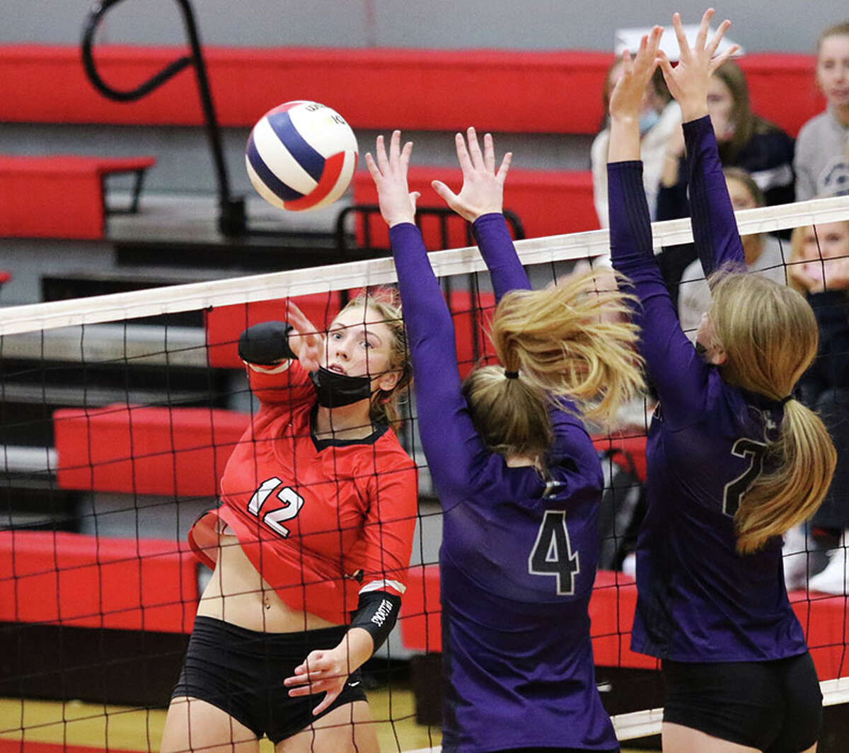 Staunton's Haris Legendre (left) hits past a double block put up by Breese Central in last season's Class 2A sectional semifinals at Vandalia. Legendre is the 2021 Telegraph Small-Schools Girls Volleyball Player of the Year.