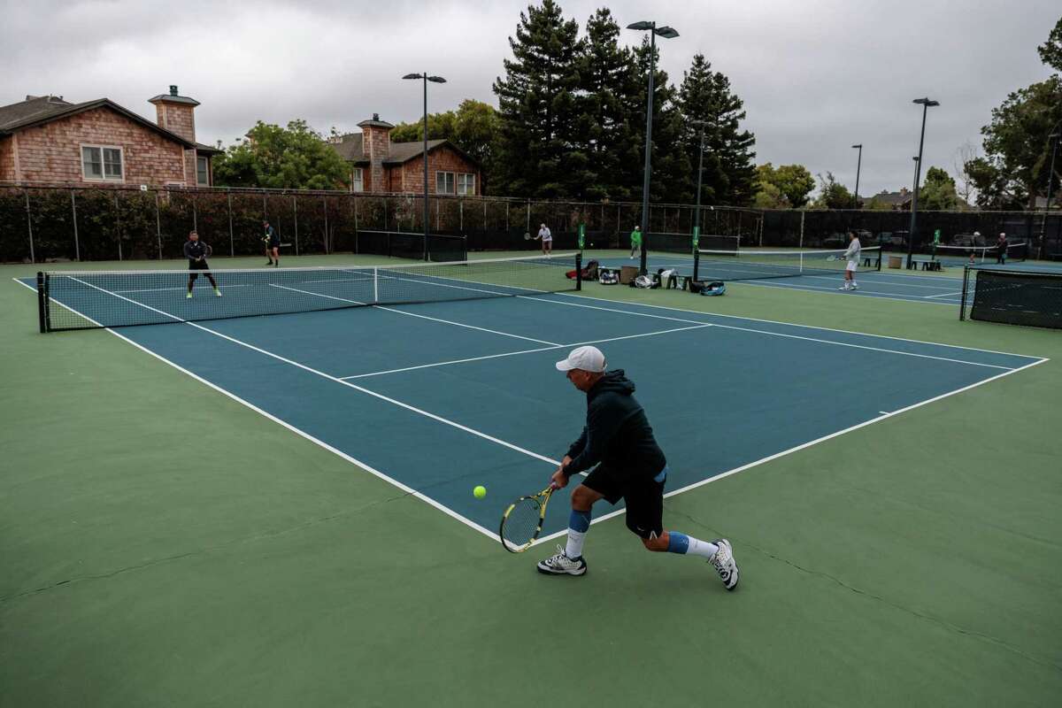 Jeff Petersen plays tennis with his friends at the Harbor Bay Club in Alameda, Calif., on Thursday, Jun 30, 2022.