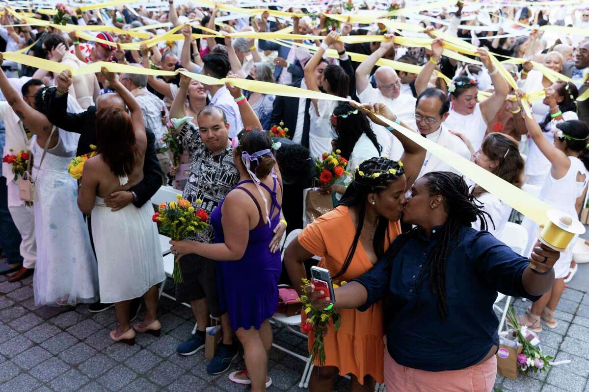 Couples, whose weddings were cancelled or diminished during the COVID-19 pandemic, participate in a symbolic multicultural ceremony at Damrosch Park, Sunday, July 10, 2022, in New York. The evening culminated with a reception on the dance floor at The Oasis and is a part of Lincoln Center's "Summer for the City." (AP Photo/Julia Nikhinson)