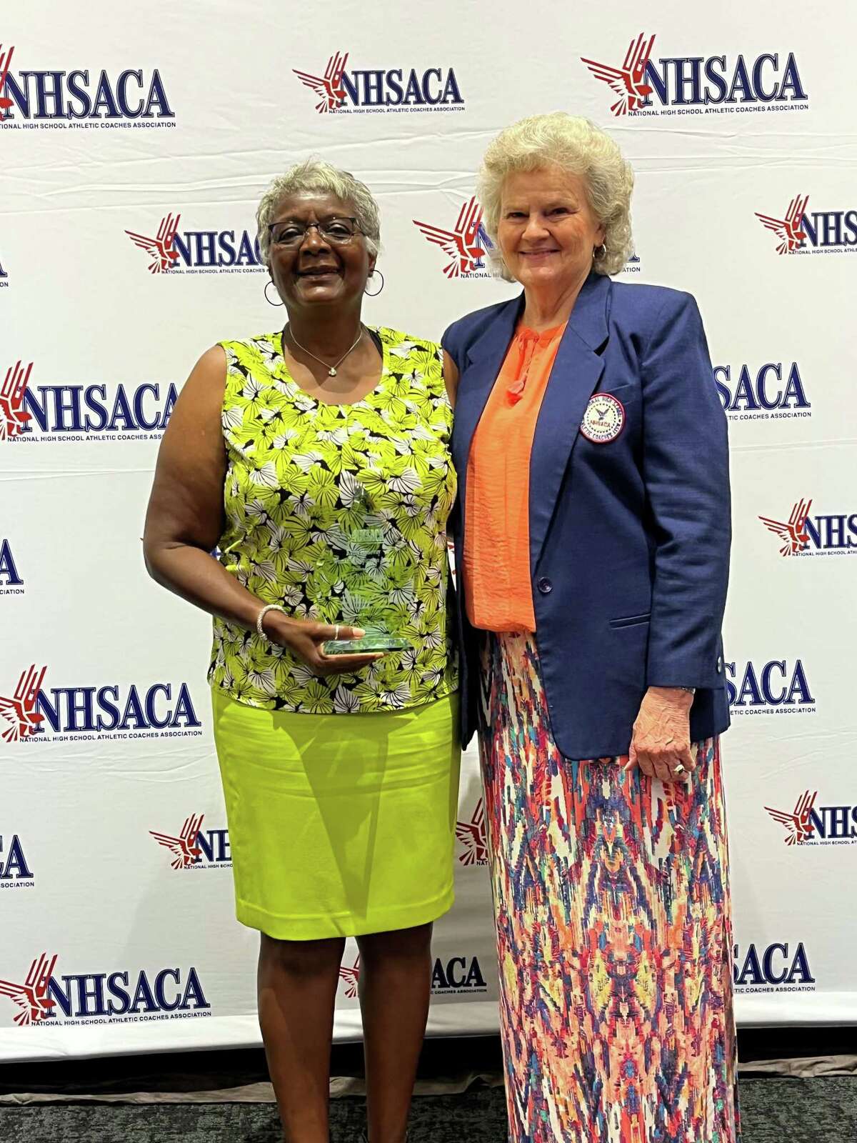 Deb Petruzzello, left, with Kathy Holloway after receiving the Kathy Holloway Women of Inspiration Award at the National High School Athletic Coaches Association convention last month in Iowa.