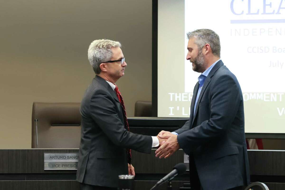 CCISD Superintendent Eric Williams shakes hands with Board Trustee Jonathan Cottrell during the Clear Creek Independent School district special meeting on July 11, 2022.