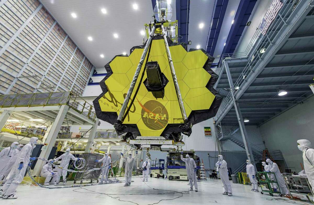 FILE - In this April 13, 2017, photo provided by NASA, technicians lift the mirror of the James Webb Space Telescope using a crane at the Goddard Space Flight Center in Greenbelt, Md. NASA is releasing the first images from the new telescope this week. (Laura Betz/NASA via AP, File)
