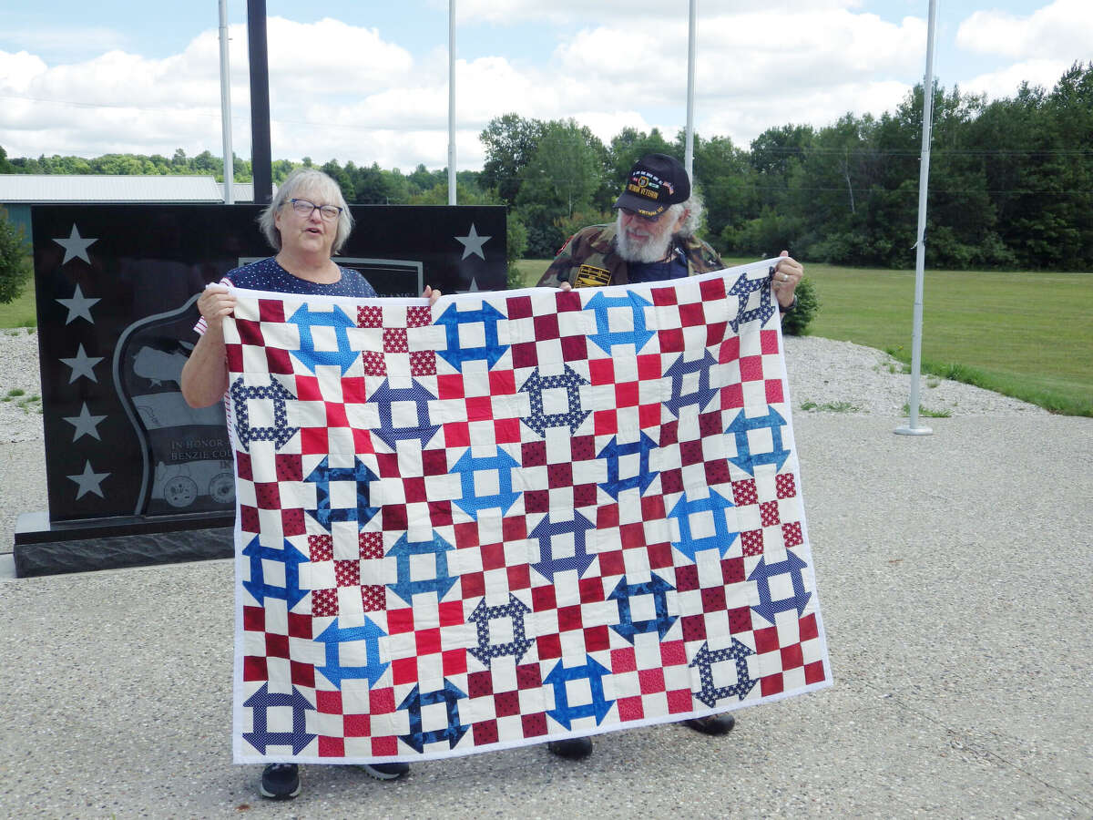 Linda Bulah, from Quilts Of Valor, Grand Rapids, presents a Quilt of Valor to veteran Robert Bodell on July 6 during a short ceremony at the Benzie County Veterans' Memorial. 