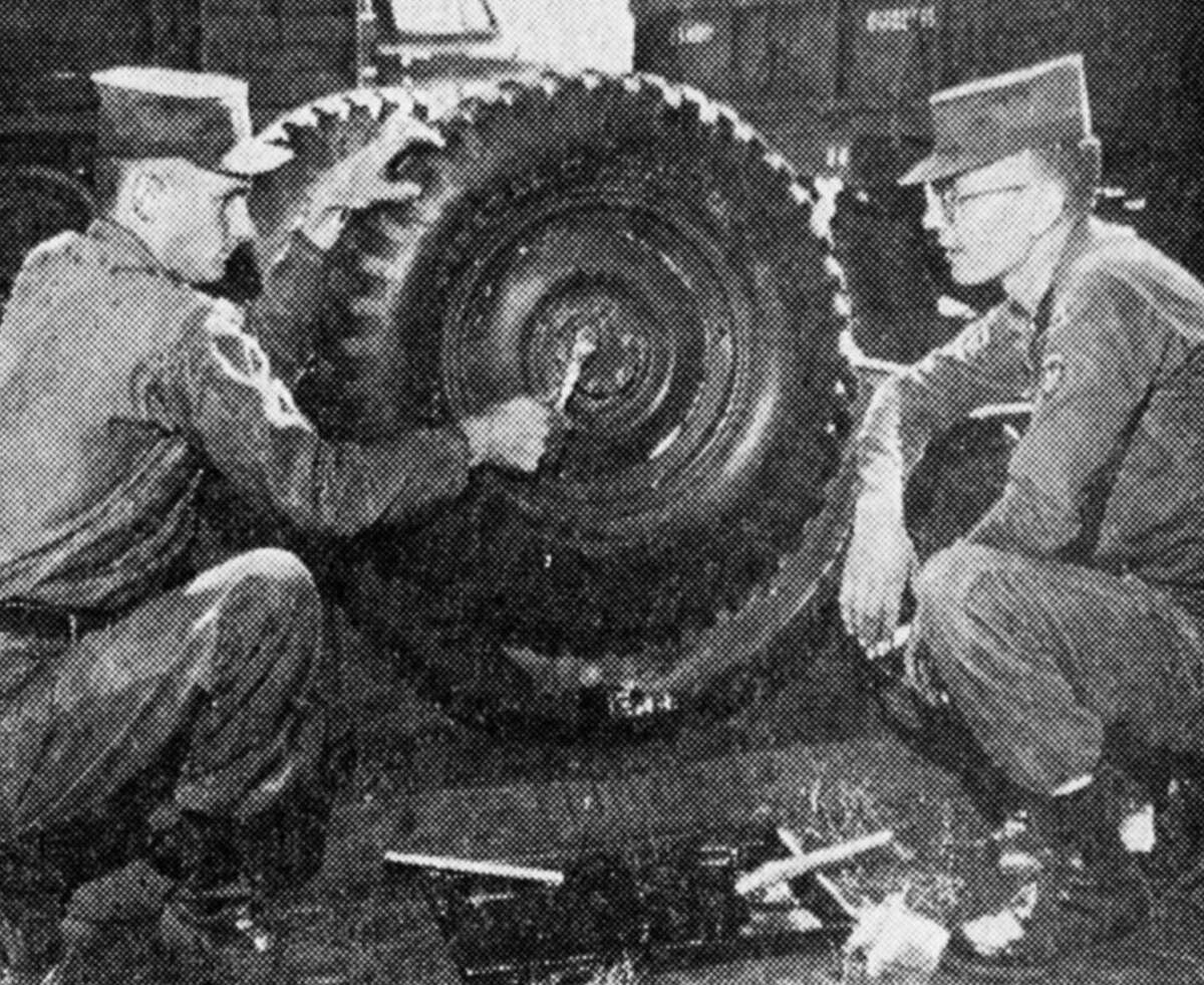 The Manistee National Guard Unit recently spent a two-week encampment at Camp Grayling. Here, two guardsmen fix a tire. The photo was published in the News Advocate on July 14, 1962.