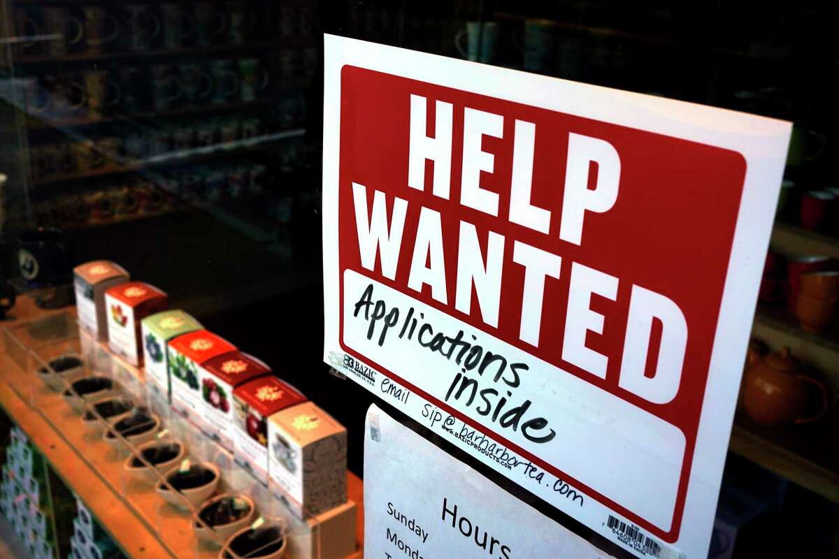 A help-wanted sign hangs in the front window of the Bar Harbor Tea Room, Saturday, June 11, 2022. (AP Photo/Robert F. Bukaty, File)