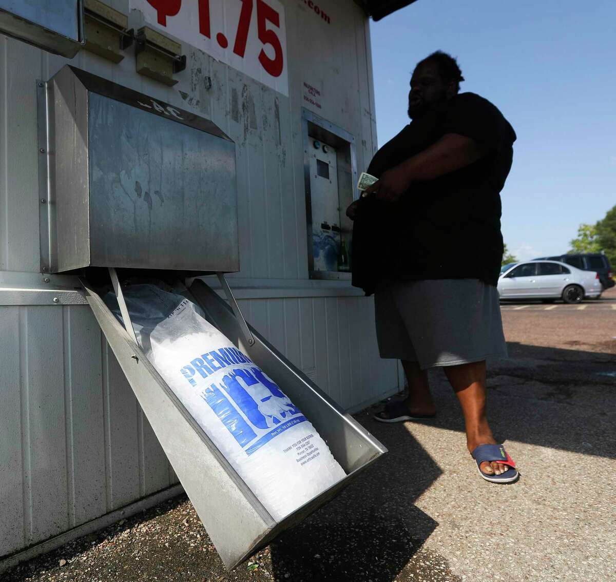 Jerlon Barbar gets ice from a dispenser, Tuesday, July 12, 2022, in Conroe. Conroe reached 105 degrees on Sunday and 103 degrees on Monday and forecasters say temperatures around 100 remain likely for Tuesday and Wednesday under sunny skies. Thursday and Friday may be slightly cooler, with highs in the mid-90s. The weekend forecast calls for highs somewhere in the mid-90s with scant rain chances under mostly sunny skies.