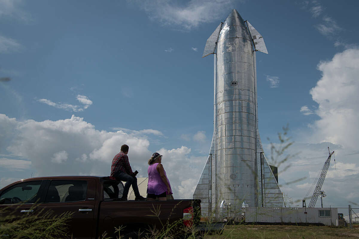 BOCA CHICA, TX - SEPTEMBER 28: Space enthusiasts look at a prototype of SpaceX's Starship spacecraft at the company's Texas launch facility on September 28, 2019 in Boca Chica near Brownsville, Texas. The Starship spacecraft is a massive vehicle meant to take people to the Moon, Mars, and beyond. (Photo by Loren Elliott/Getty Images)