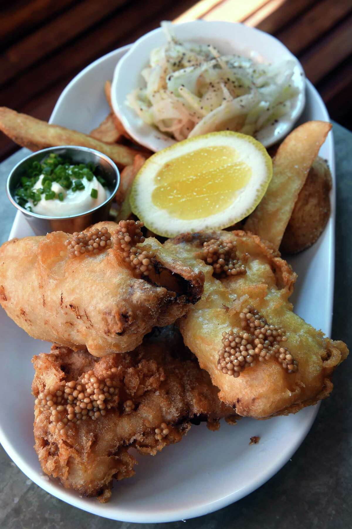 Beer battered hake with pickled mustard seeds, fennel slaw and malt vinegar aioli photographed at the Fair Haven Oyster Co. on Front Street in New Haven on July 12, 2022.