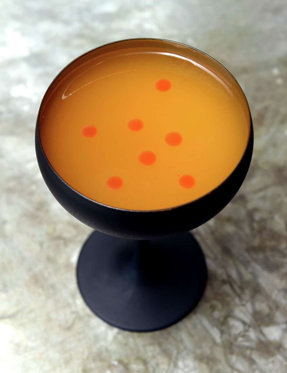 The Bad Alibi consisting of tequila mezcal, ancho reyes, passionfruit and chili oil photographed at the Fair Haven Oyster Co. on Front Street in New Haven on July 12, 2022.