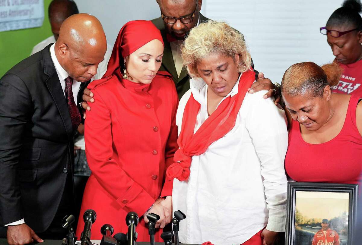 Haleem Muhammad, center, leads a prayer with Deric Muhammad, from left, Sadiyah Evangelista, Demetria Brooks Glaze and Sandra Brooks after talking to the media about Roderick Brooks, who was shot and killed July 8, 2022, by a Harris County Sheriff's Office deputy, on Tuesday, July 12, 2022 in Houston.