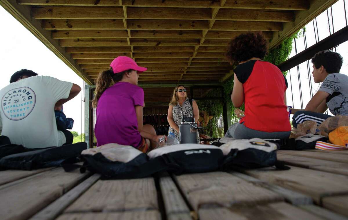 Karla Klay, executive director of Artist Boat, talks with a group of teenage summer campers about their experience on June 14, 2022, in Galveston.