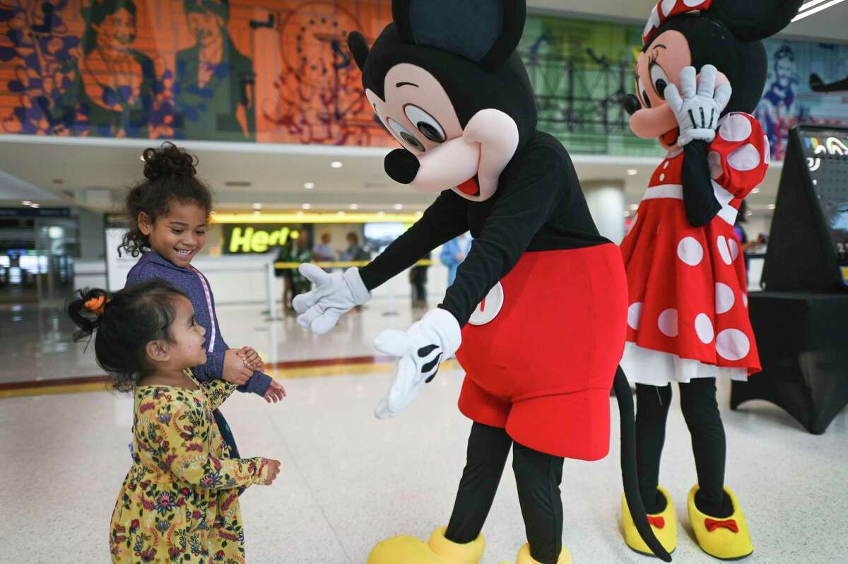 Children are greeted by Mickey Mouse at San Antonio International Airport during an event to announce the airline’s new service to Las Vegas and Orlando.