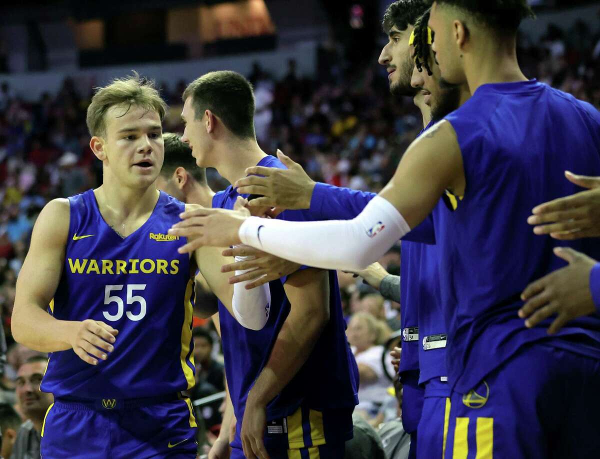 LAS VEGAS, NEVADA - JULY 10: Mac McClung #55 of the Golden State Warriors is congratulated by teammates on the bench as he checks out of a game against the San Antonio Spurs during the 2022 NBA Summer League at the Thomas & Mack Center on July 10, 2022 in Las Vegas, Nevada. NOTE TO USER: User expressly acknowledges and agrees that, by downloading and or using this photograph, User is consenting to the terms and conditions of the Getty Images License Agreement. (Photo by Ethan Miller/Getty Images)