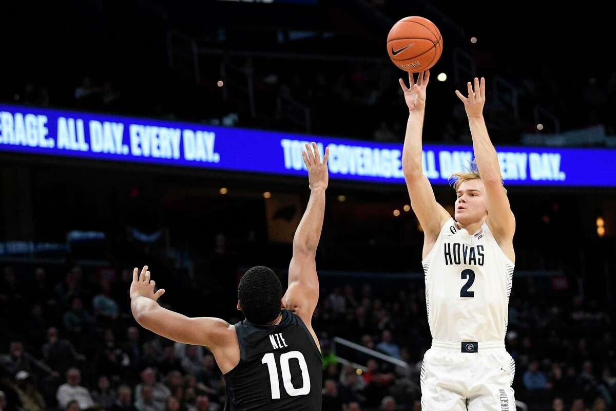 FILE - In this Jan. 28, 2020, file photo, Georgetown guard Mac McClung (2) shoots as he is defended by Butler forward Bryce Nze (10) during the second half of an NCAA college basketball game, in Washington. Former Georgetown guard McClung has signed with Texas Tech after Davide Moretti's departure from the Red Raiders to play professionally at home in Italy. Coach Chris Beard said Thursday, May 28, 2020, that McClung had officially signed with the Red Raiders. (AP Photo/Nick Wass, File)