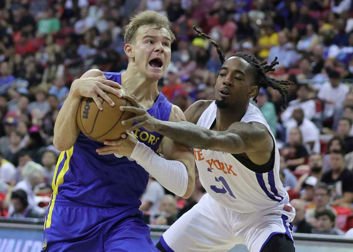 Mac McClung of the Warriors drives against Quinton Rose of the New York Knicks in a summer league game.