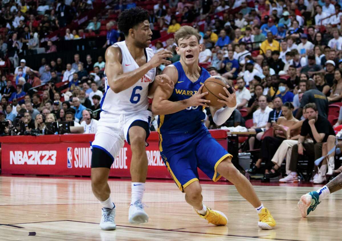 Mac McClung, playing with the Warriors’ Las Vegas summer league team, maneuvers past Quentin Grimes of the New York Knicks. McClung averaged 13.4 points per game in Las Vegas.