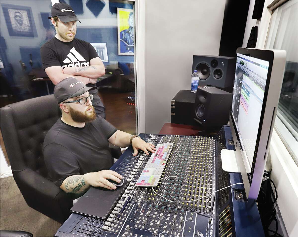 The Old Mississippi Sound House founder, owner, engineer, videographer and artist Modert Clark, sitting, and engineer Hobie Hobart work at the studio's sound mixing station inside the Milton Schoolhouse. The studio opened its doors in 2019.