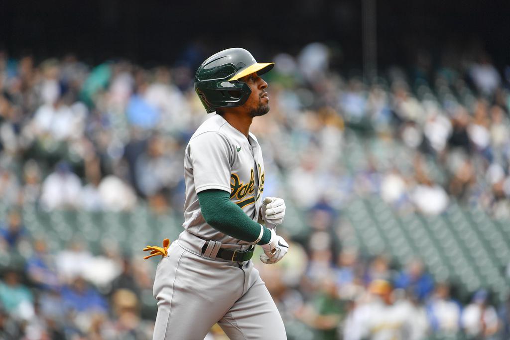 Oakland Athletics left fielder Tony Kemp, left, changes into his jersey in  the dugout before the team's baseball game against the Miami Marlins in  Oakland, Calif., Monday, Aug. 22, 2022. (AP Photo/Godofredo