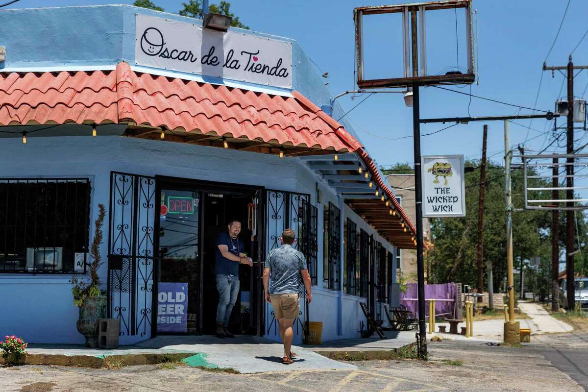 People walk in and out of Oscar de la Tienda, the Alta Vista neighborhood convenience store located on the corner of North Flores Street and West Russell Place. The Wicked Wich sandwich shop is also located inside the store.