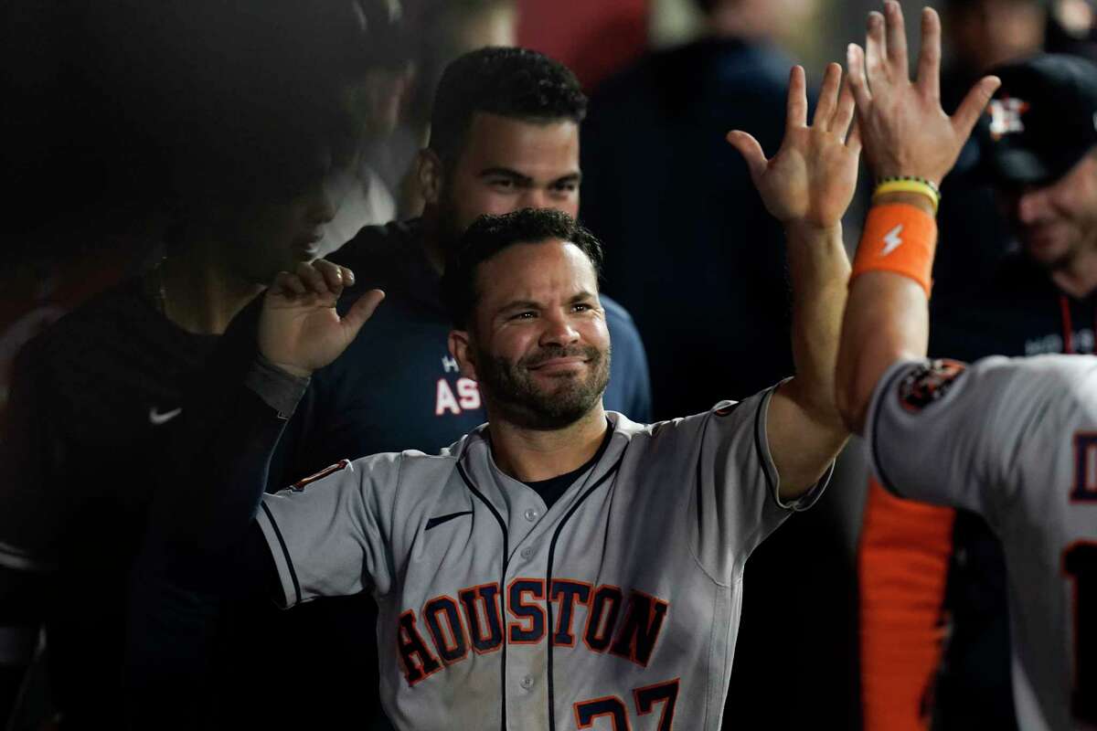 Houston Astros' Jose Altuve is greeted by teammates after he scored on a double by Kyle Tucker during the ninth inning of the team's baseball game against the Los Angeles Angels on Tuesday, July 12, 2022, in Anaheim, Calif. (AP Photo/Jae C. Hong)