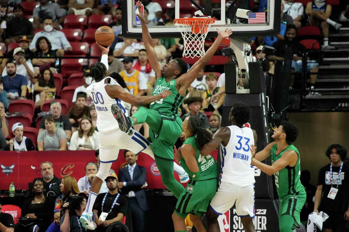 Boston Celtics' Mfiondu Kabengele attempts to block a shot by Golden State Warriors' Jonathan Kuminga during the second half an NBA summer league basketball game Tuesday, July 12, 2022, in Las Vegas. (AP Photo/John Locher)
