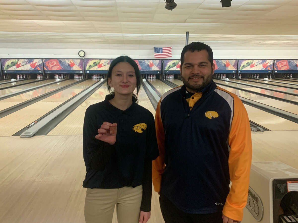Baldwin's Rachel Carpenter (left) and her coach Duane Roberts celebrated her medal-winning performance at the regionals.