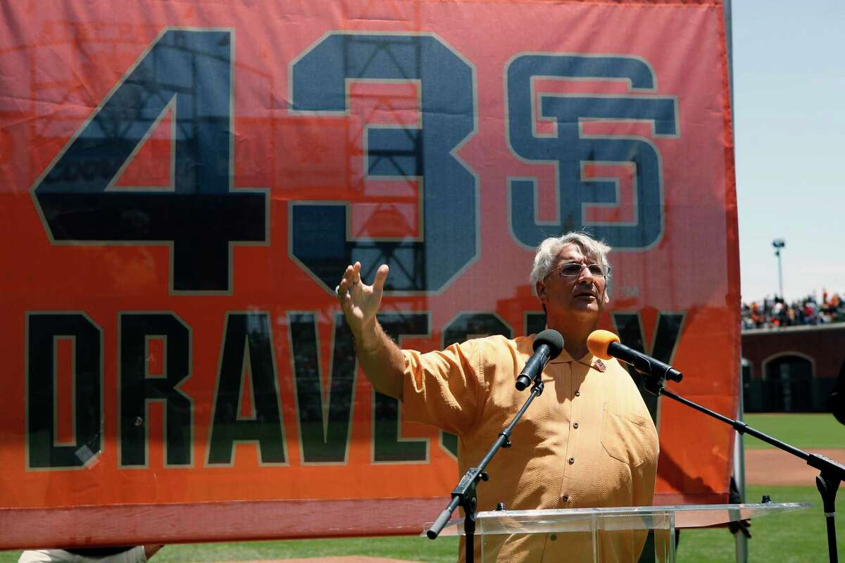 Former San Francisco Giants pitcher Dave Dravecky, right, stands