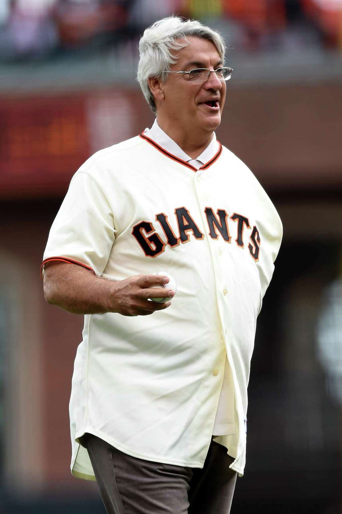 Former San Francisco Giants pitcher Dave Dravecky, right, stands