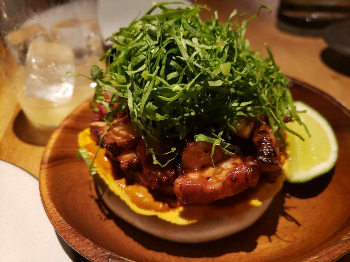 Tender sliced octopus, seasoned with pasilla peppers was huddled under a thatch of shaved sorrel at Cosme in New York.