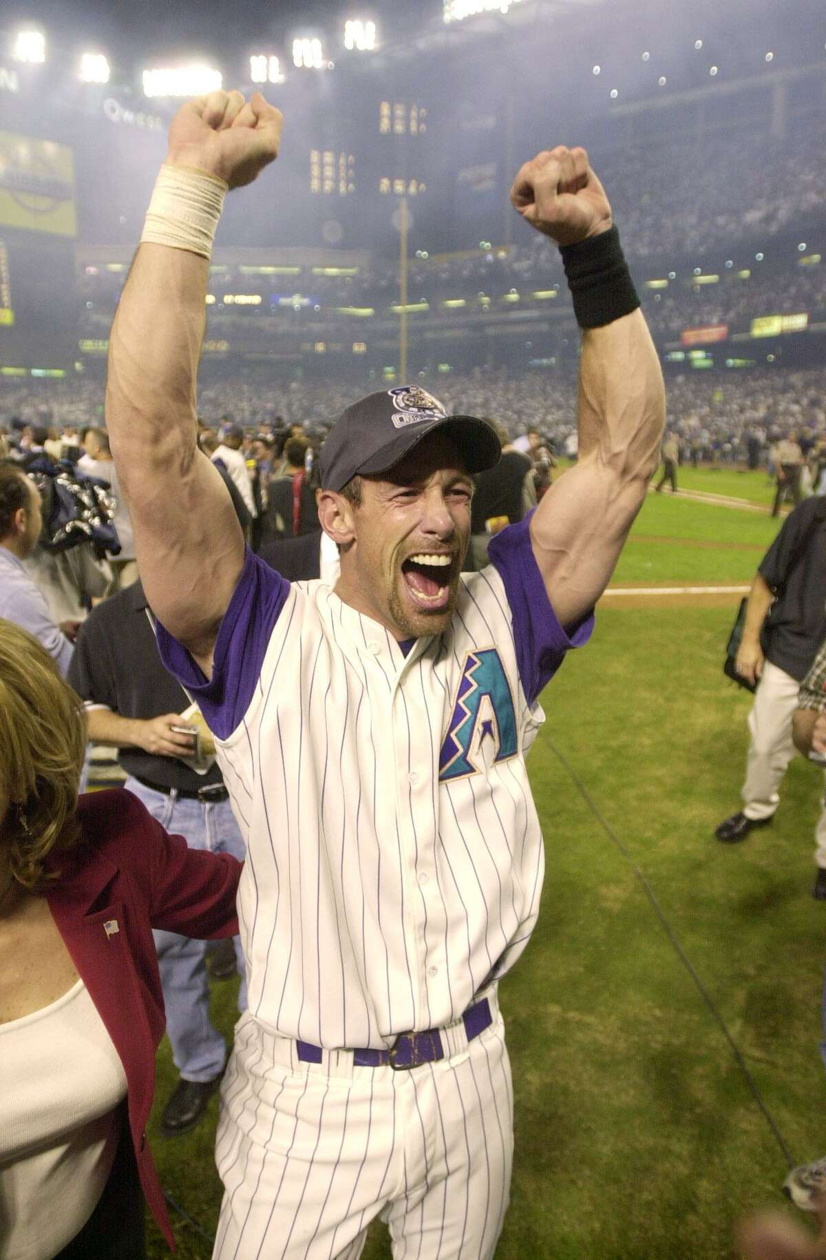 FOR USE WITH YEAR END STORIES Arizona Diamondbacks' Luis Gonzalez celebrates the Diamondbacks' 3-2 victory over the New York Yankees in Game 7 of the World Series Sunday, Nov. 4, 2001, at Bank One Ballpark in Phoenix. Gonzalez drove in Jay Bell for the winning run in the ninth inning. (AP Photo/David J. Phillip). HOUCHRON CAPTION (12/30/2001): Going Gonzo: Former Astro Luis Gonzalez celebrates on the field after his bloop single lifted the Diamondbacks to the World Series title. The Year in Sports: TOP 10 NATIONAL STORIES OF 2001.