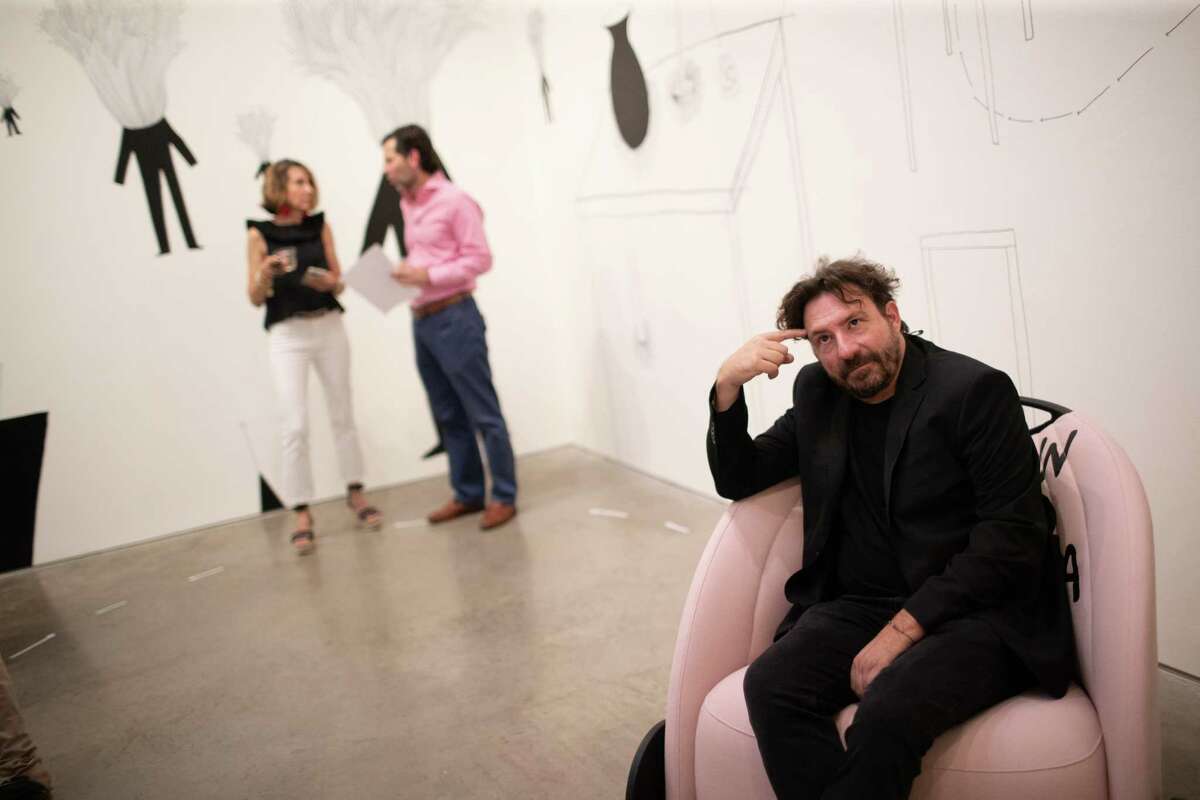 Italian artist Andrea Bianconi sits on a ‘Sit Down To Have an Idea’ limited edition BIGA chair at the Barbara Davis Gallery, Friday, July 8, 2022, in Houston. Bianconi is the artist responsible for the ‘Sit Down To Have an Idea’ exhibition.
