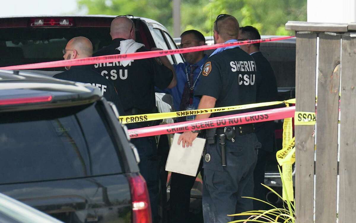 Harris County Sheriff’s Office officials investigate a deputy-involved shooting at Scottish Inns & Suites on Kuykendahl on Wednesday, July 13, 2022 in Houston.