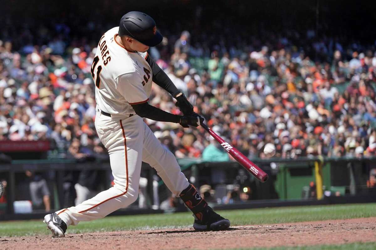 San Francisco Giants' Wilmer Flores hits a home run against the Arizona Diamondbacks during the eighth inning of a baseball game in San Francisco, Wednesday, July 13, 2022. (AP Photo/Jeff Chiu)