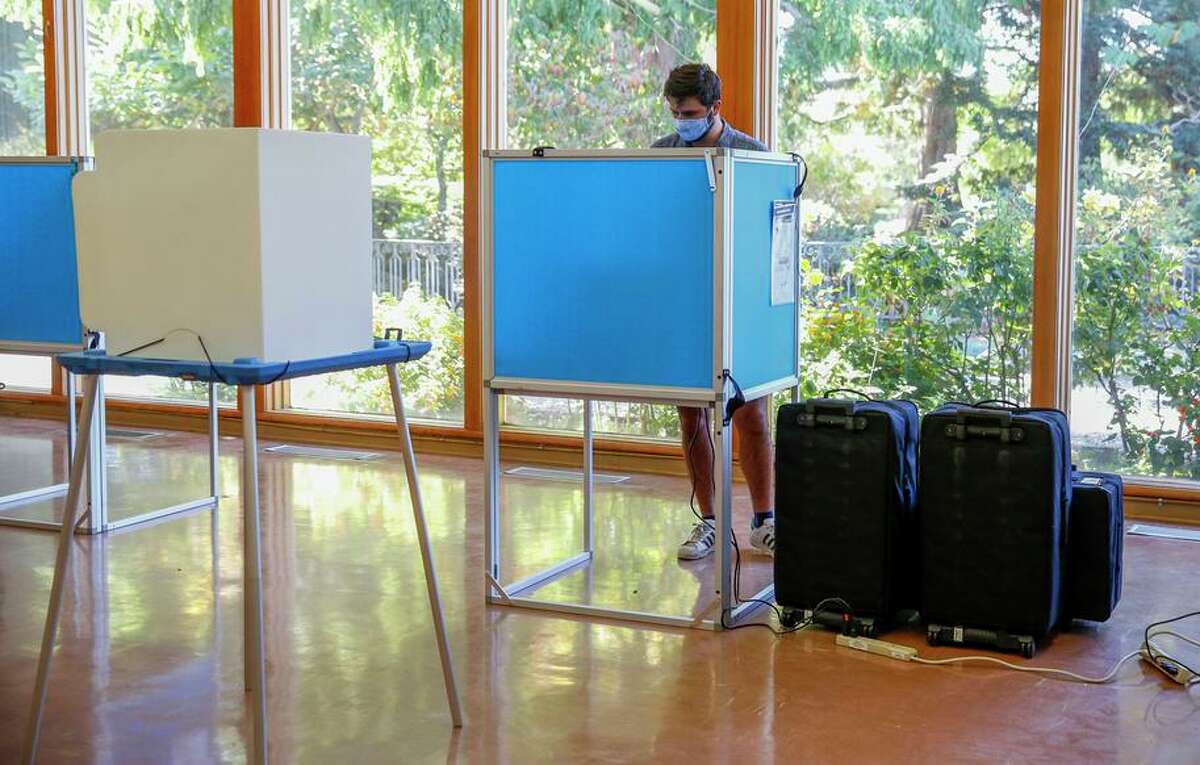 FILE-An Oakland voter casts their ballot in the recall election in Oakland, Calif., on Tuesday, September 14, 2021.