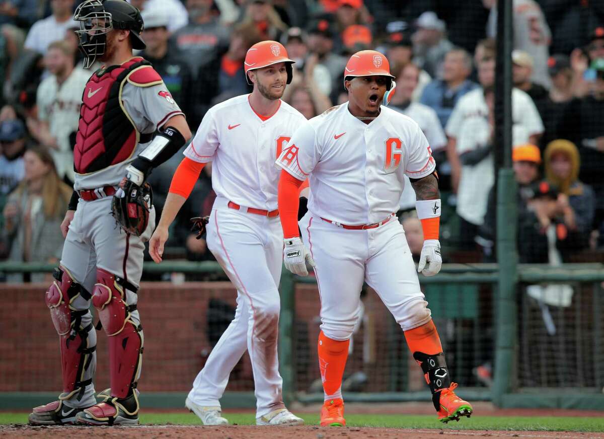 Yermin Mercedes, right, reacts at home after high-fiving Austin Slater after hitting a two-run home run in the second inning of Tuesday’s game at Oracle Park.