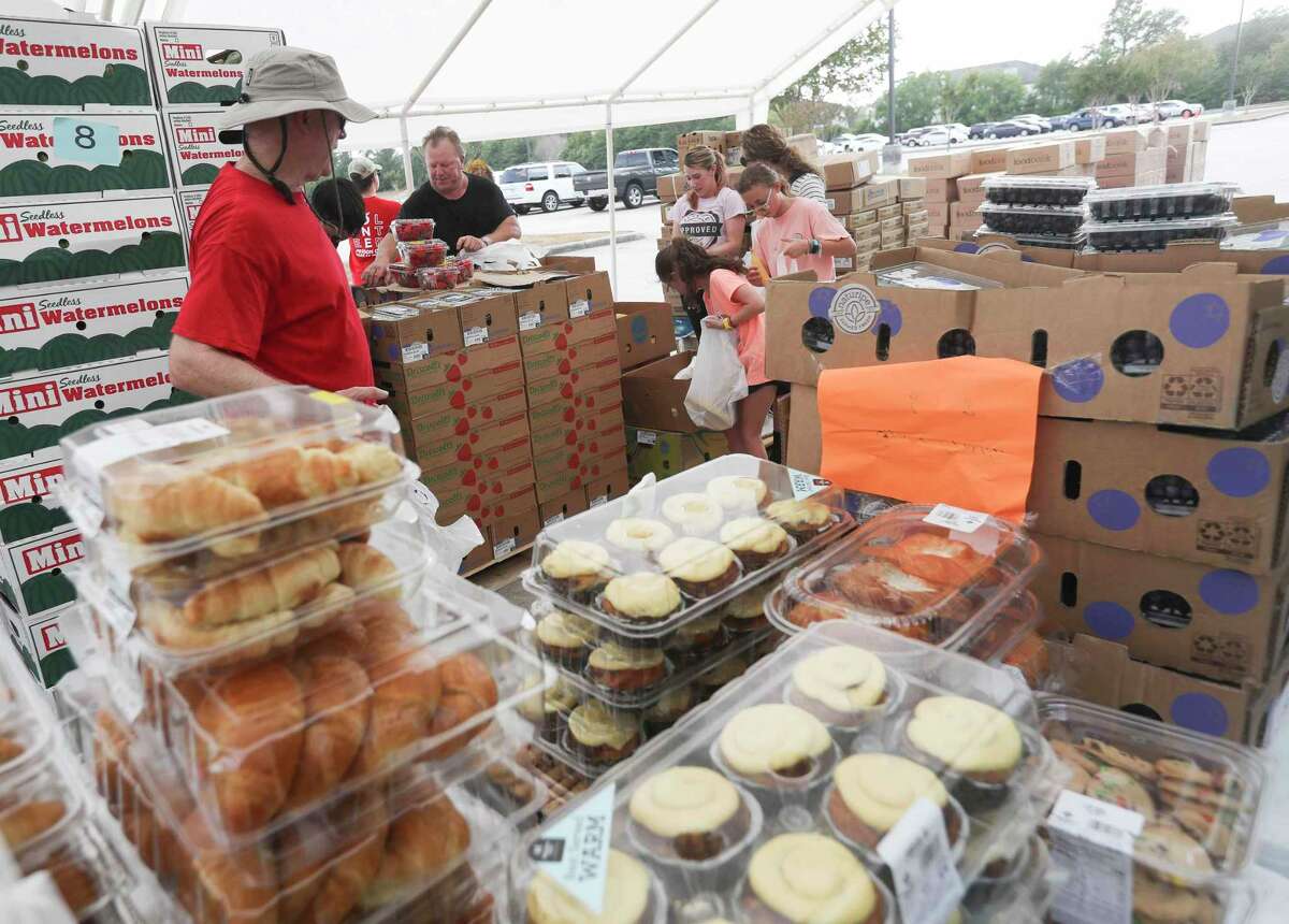 Volunteers helps distribute 125 meals during a mobile food market from the Montgomery County Food Bank, Wednesday, July 13, 2022, in Conroe.