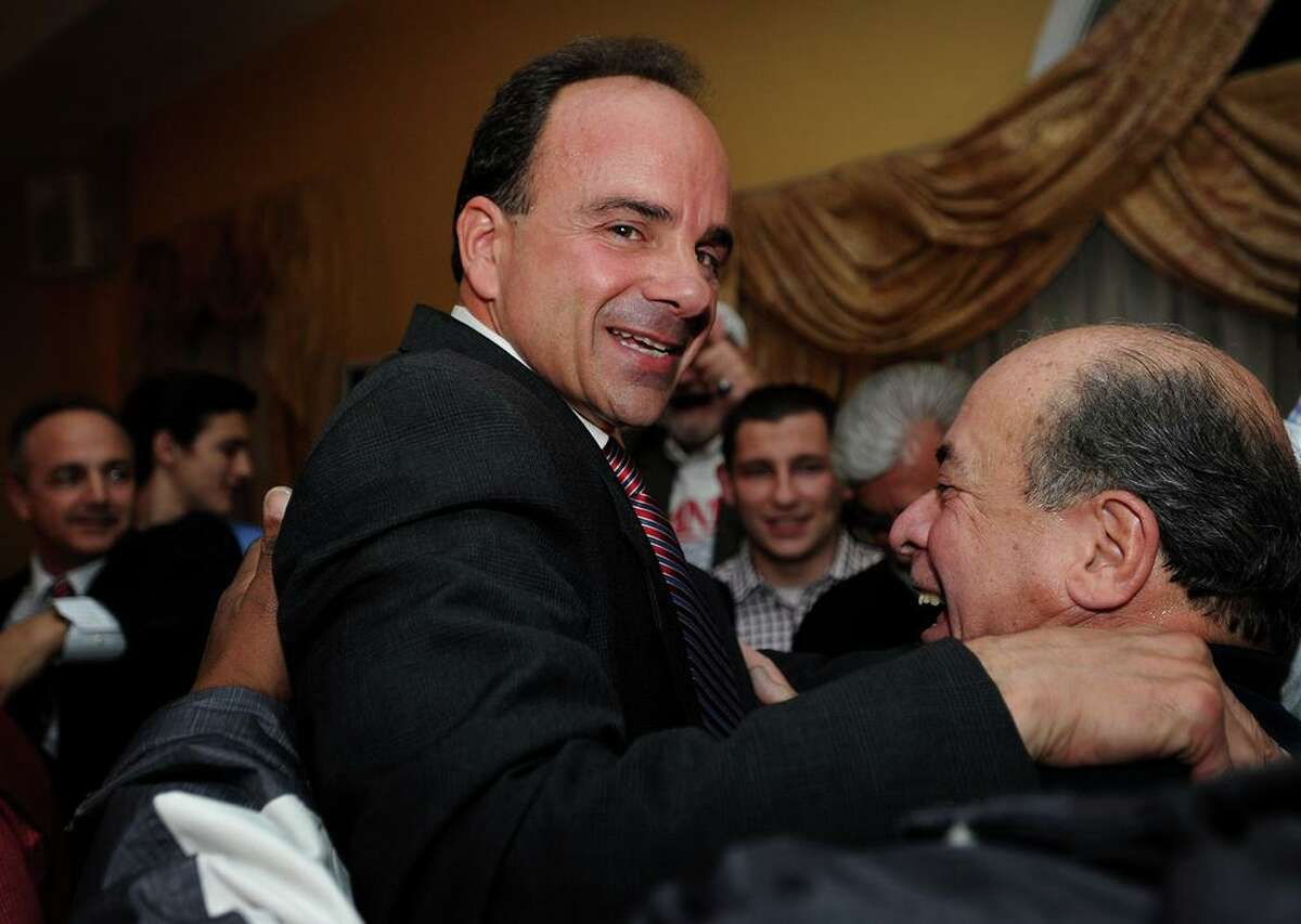 Joseph Ganim, left, is hugged by city employee Raul Laffitte after winning the election as Bridgeport's new mayor at Testo's Restaurant in Bridgeport, Conn. on Tuesday, November 3, 2015.