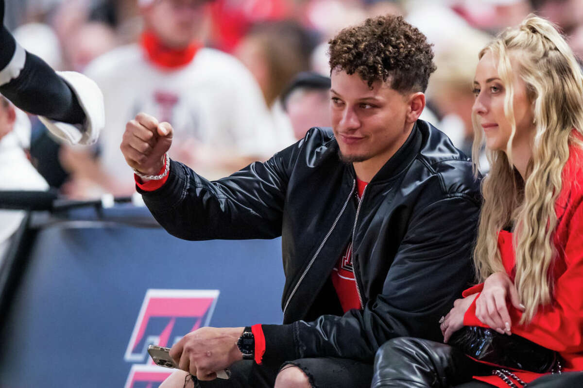 LUBBOCK, TEXAS - FEBRUARY 16: Quarterback Patrick Mahomes of the Kansas City Chiefs fist bumps mascot Raider Red during the first half of the college basketball game between the Texas Tech Red Raiders and the Baylor Bears at United Supermarkets Arena on February 16, 2022 in Lubbock, Texas. (Photo by John E. Moore III/Getty Images)