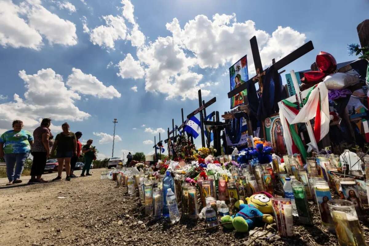 Mourners visited a memorial on July 1, 2022, at the site in San Antonio where dozens of migrants were found after dying in an abandoned tractor-trailer. Credit: Chris Stokes for The Texas Tribune