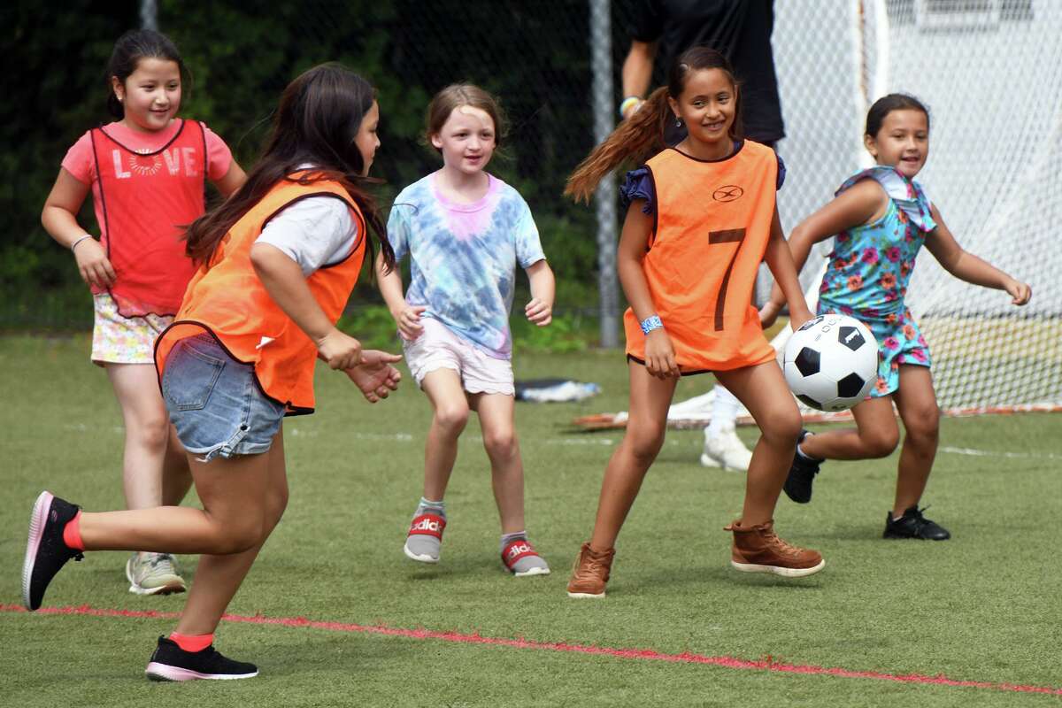 Kids play soccer during a health, wellness and soccer day camp at Wakeman Boys & Girls Club, in Fairfield, Conn. July 14, 2022.