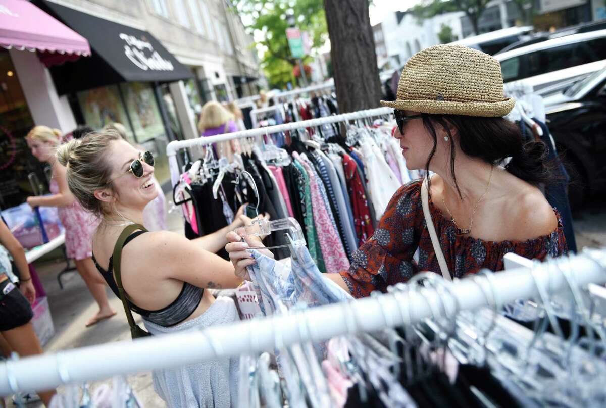 New York resident Dani Hunt, left, and Greenwich resident Tamra Sanford shop at Petticoat Lane during the 2022 Sidewalk Sales in Greenwich, Conn. Thursday, July 14, 2022. Presented by the Greenwich Chamber of Commerce, dozens of businesses participated in the sale by displaying their goods on the sidewalk at heavily marked-down prices. The sales continue from 9 a.m. to 7 p.m. Friday and Saturday and from 9 a.m. to 5 p.m. Sunday.