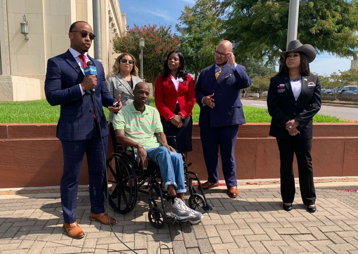 Attorney Preston Strickland of Houston-based Strickland Law Firm on Thursday addresses the lawsuit his client Christopher Shaw, center, and other attorneys are filing after Shaw was paralyzed while in the custody of Beaumont Police. Photo taken July 14, 2022. Photo by Olivia Malick/The Enterprise